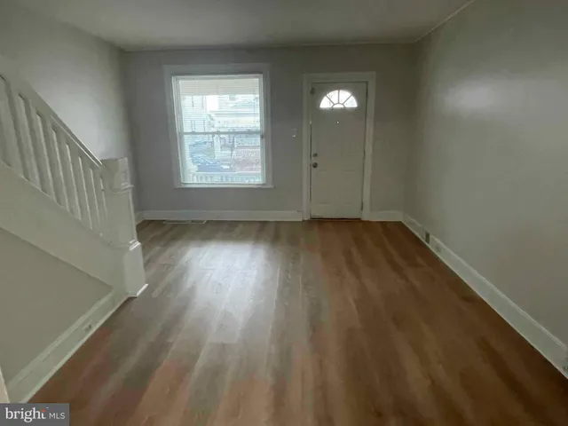 a view of an empty room and wooden floor