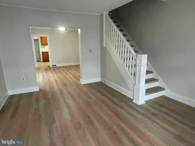 a view of entryway and hall with wooden floor