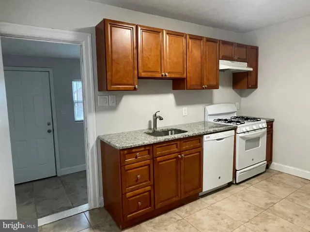 a kitchen with a sink cabinets and window