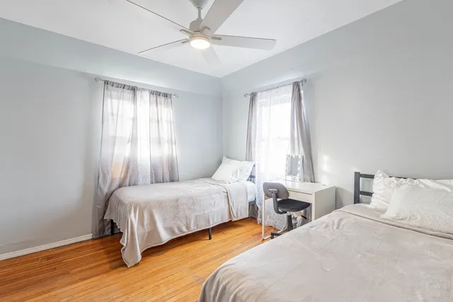 a bedroom with two beds and a chandelier