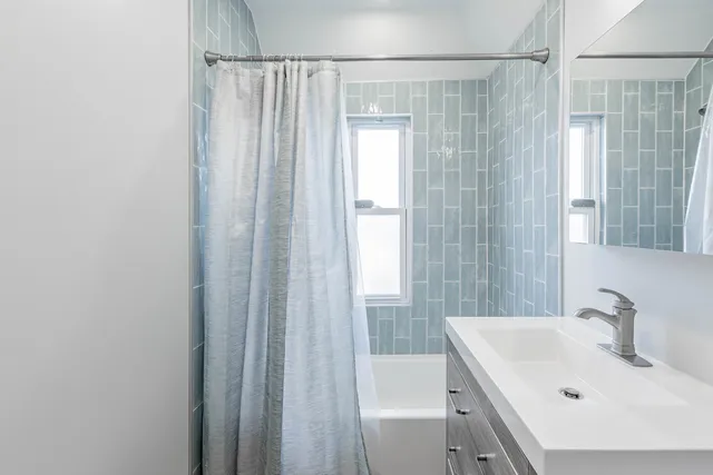 a bathroom with a sink a mirror and a shower