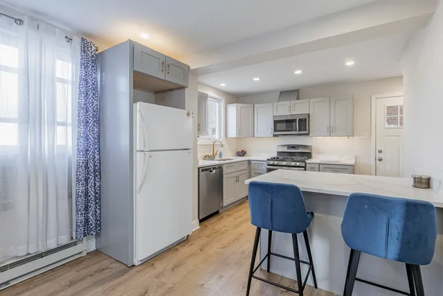 a kitchen with cabinets and stainless steel appliances