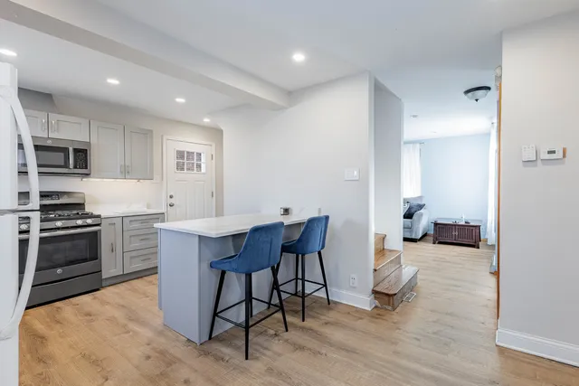 a kitchen with a sink cabinets and stainless steel appliances