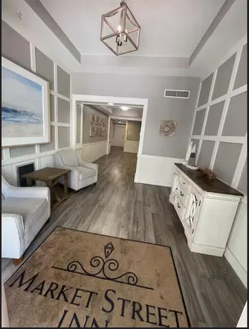 a view of living room with furniture and wooden floor