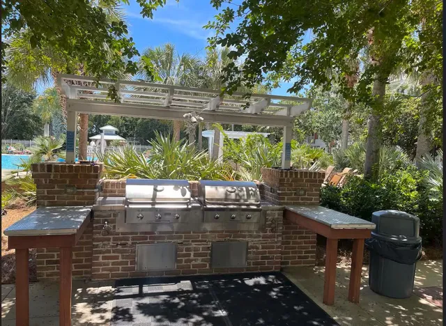 a view of a patio with table and chairs potted plants