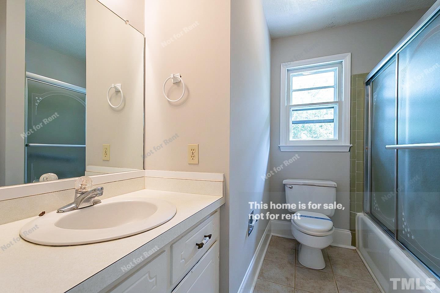 4120 Green Road Raleigh, NC 27604 - Photo 4 of 16 a bathroom with a toilet sink and mirror