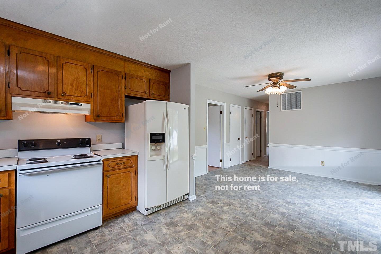 4120 Green Road Raleigh, NC 27604 - Photo 6 of 16 a kitchen with refrigerator and cabinets