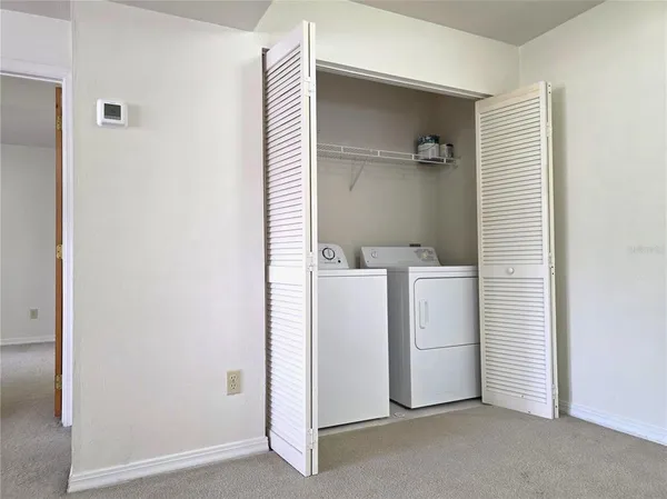 a kitchen with a refrigerator and a stove top oven