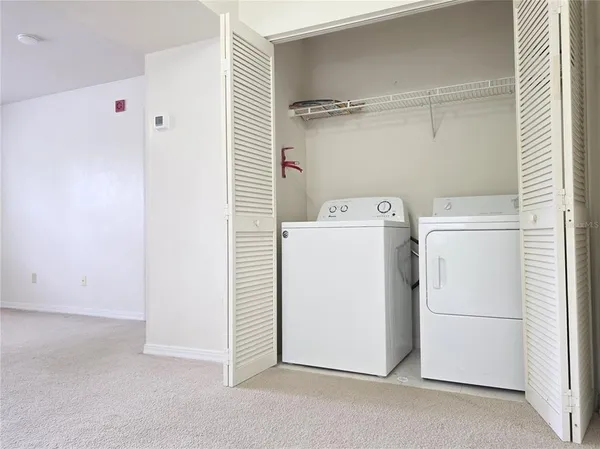a kitchen with stainless steel appliances granite countertop white cabinets sink and window