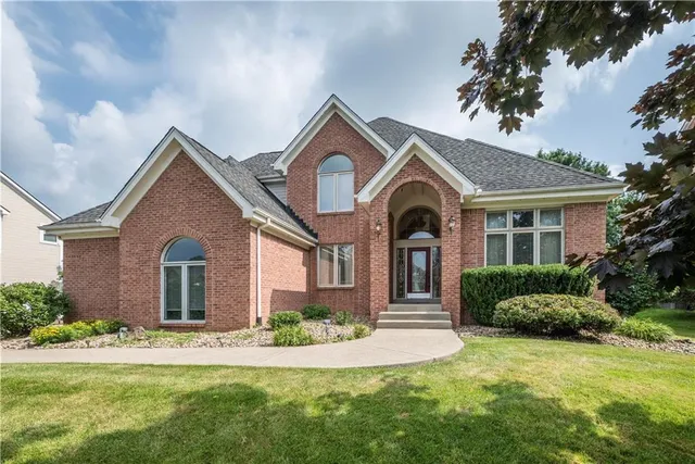 a front view of a house with a garden and plants