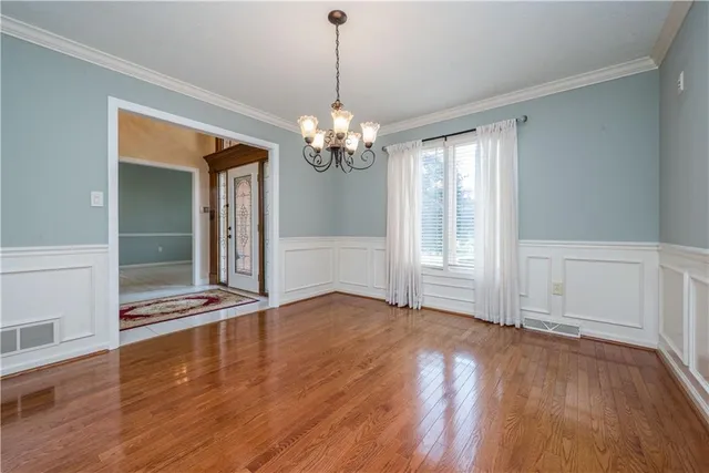 a view of livingroom with hardwood floor and kitchen view