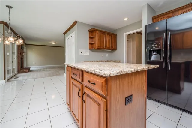 a kitchen with stainless steel appliances granite countertop a refrigerator and a sink