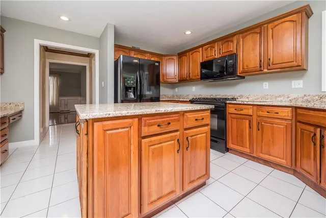 a kitchen with stainless steel appliances granite countertop a sink and cabinets