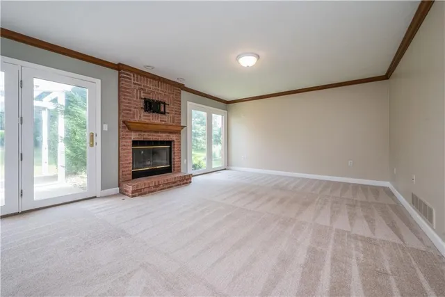 a view of empty room with a fireplace