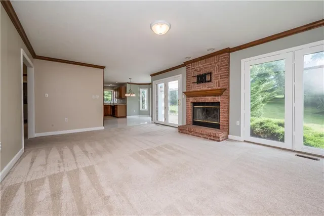 a view of a livingroom with an empty space and a fireplace