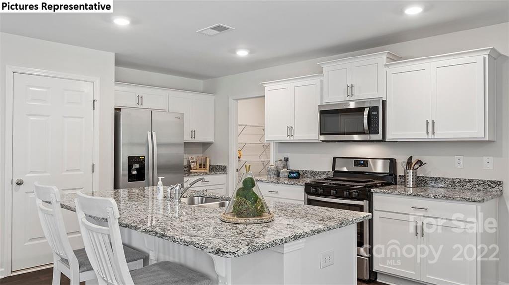 5018 Fandango Road York, SC 29745 - Photo 9 of 29 a kitchen with stainless steel appliances granite countertop a sink refrigerator and cabinets