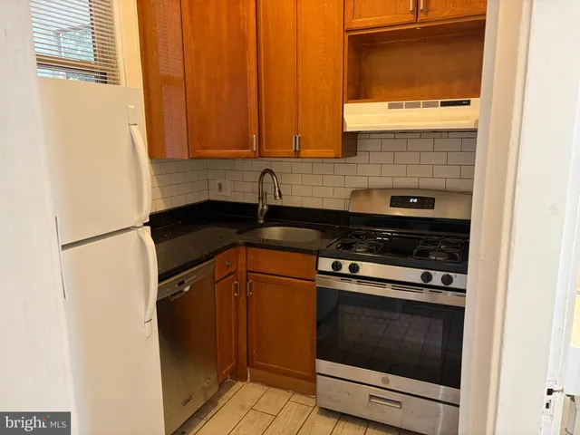 a kitchen with granite countertop cabinets and steel stainless steel appliances