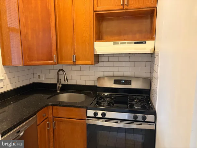 a kitchen with a stove and a sink