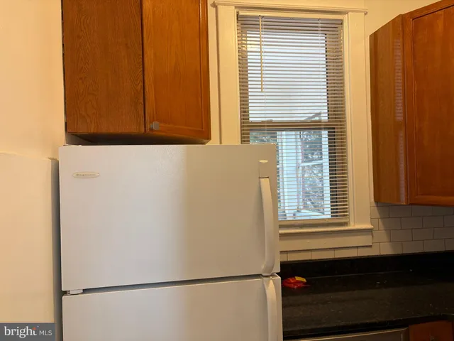 a white refrigerator freezer sitting inside of a kitchen
