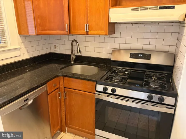 a close view of a sink a counter and appliances in the kitchen
