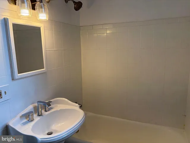 a bathroom with a sink and mirror
