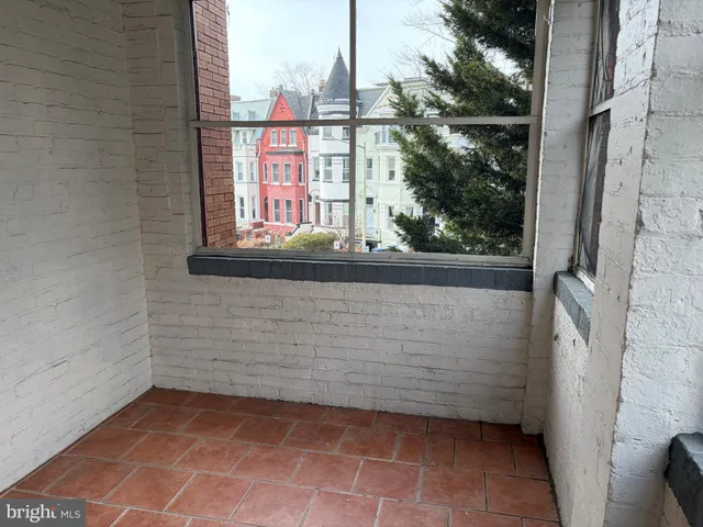 a view of a door and brick walls