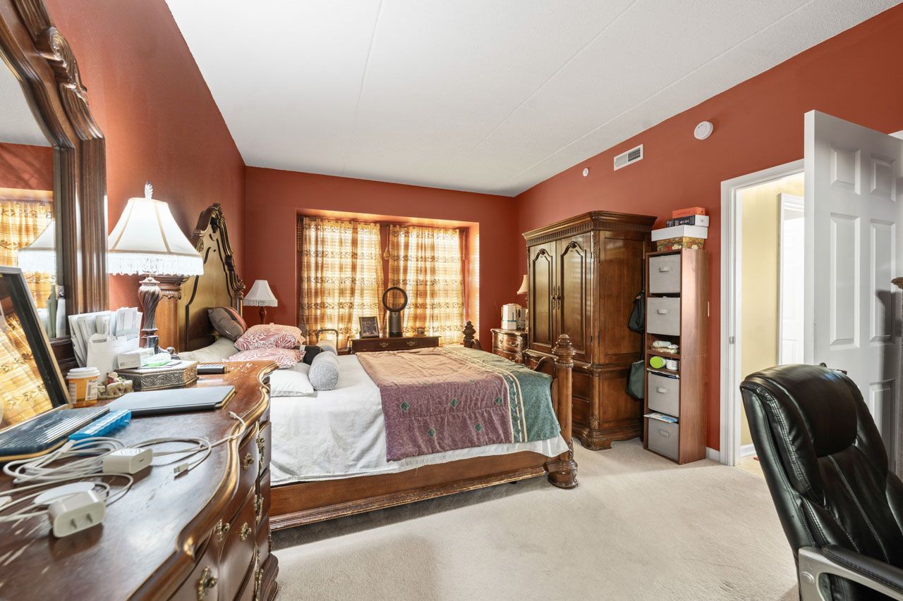 511 Prestwick Lane, Unit 302 Wheeling, IL 60090 - Photo 13 of 24 a bed room with a bed and a chair