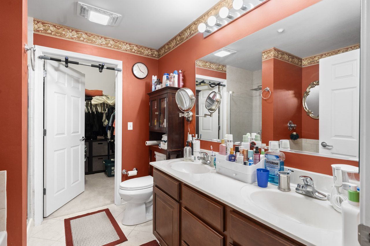 511 Prestwick Lane, Unit 302 Wheeling, IL 60090 - Photo 14 of 24 a bathroom with a sink a toilet and shower a mirror