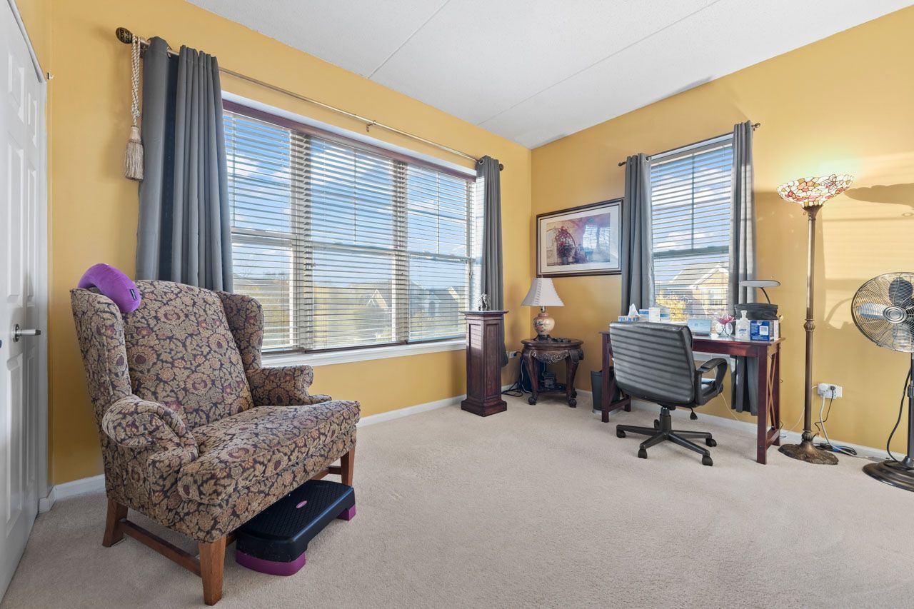 511 Prestwick Lane, Unit 302 Wheeling, IL 60090 - Photo 16 of 24 a living room with furniture and a window