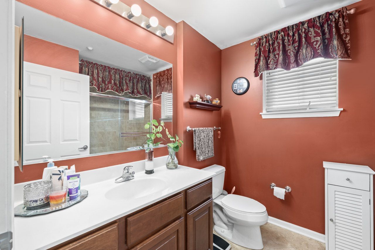 511 Prestwick Lane, Unit 302 Wheeling, IL 60090 - Photo 17 of 24 a bathroom with a sink a toilet and shower