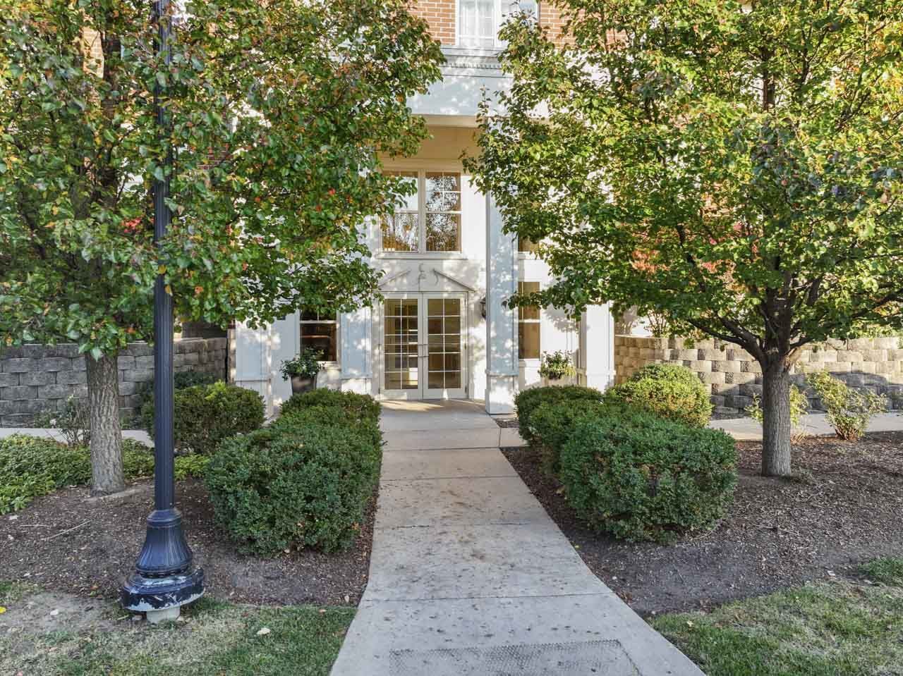511 Prestwick Lane, Unit 302 Wheeling, IL 60090 - Photo 24 of 24 a front view of a house with garden
