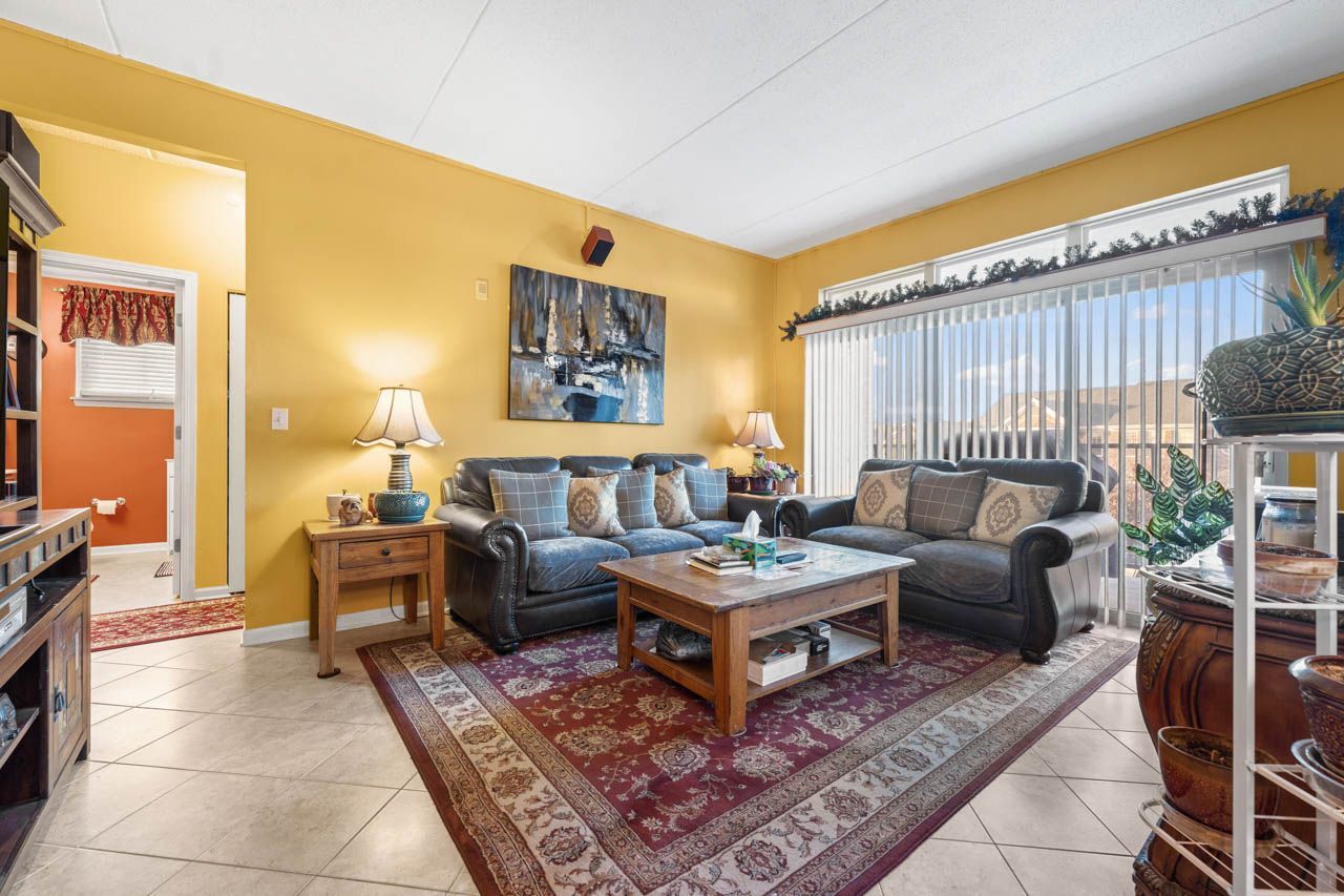 511 Prestwick Lane, Unit 302 Wheeling, IL 60090 - Photo 5 of 24 a living room with furniture a rug and a large window