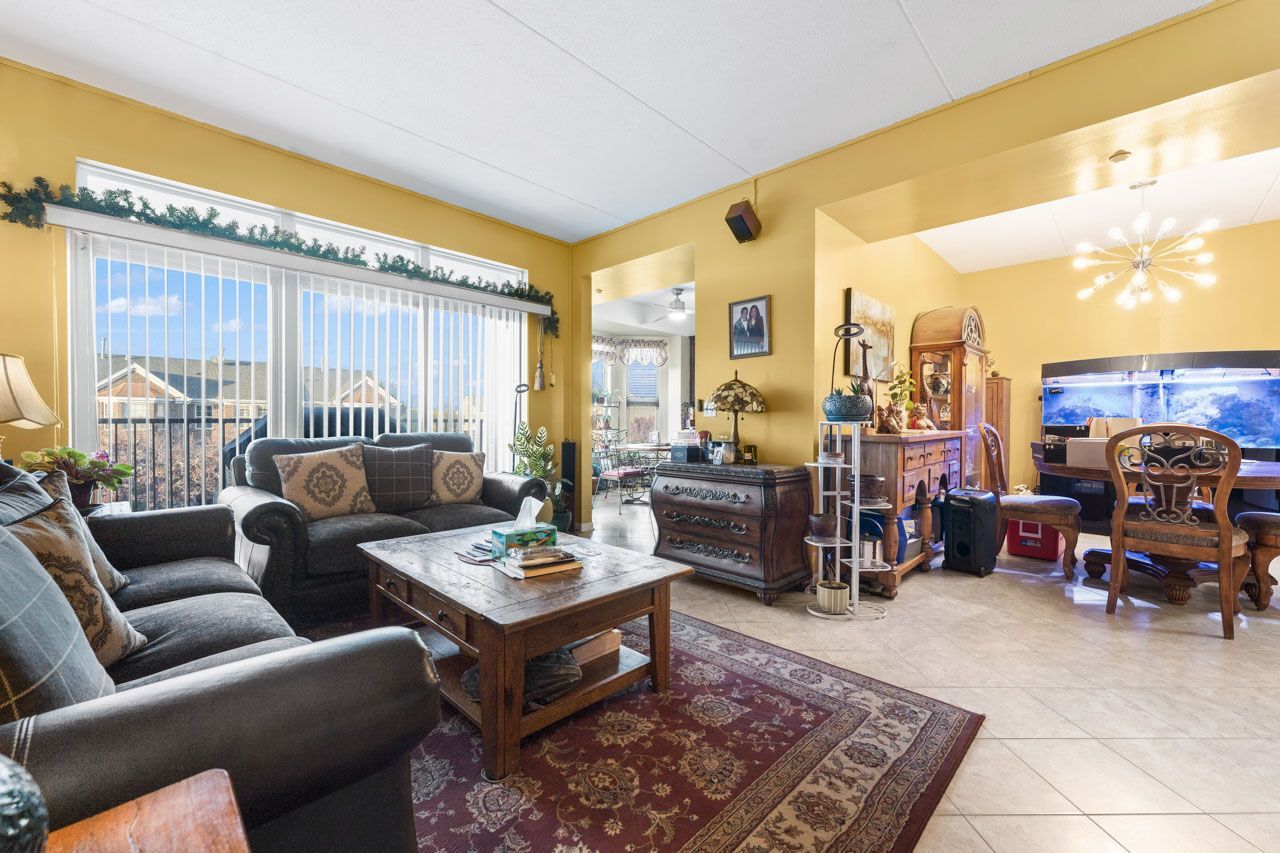 511 Prestwick Lane, Unit 302 Wheeling, IL 60090 - Photo 6 of 24 a living room with furniture and a large window