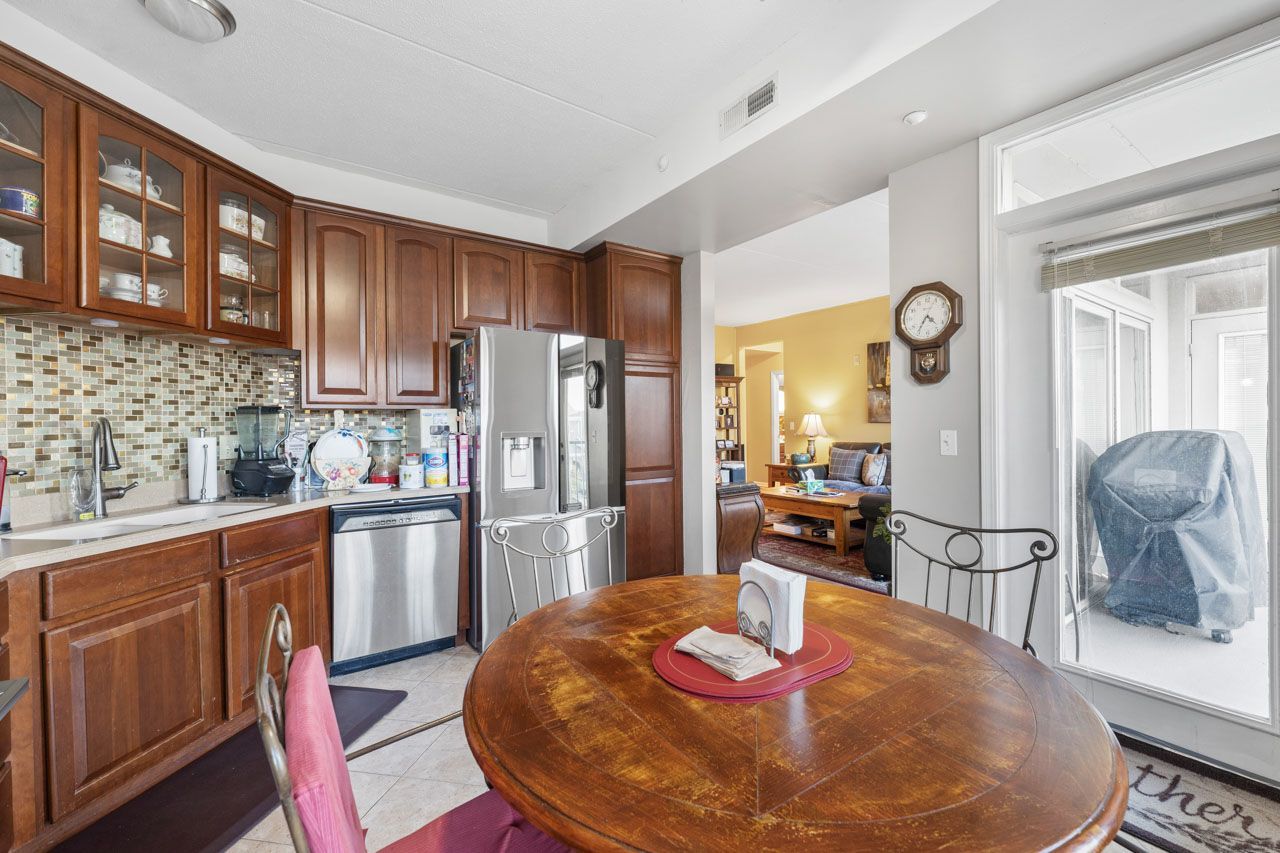 511 Prestwick Lane, Unit 302 Wheeling, IL 60090 - Photo 10 of 24 a kitchen with stainless steel appliances granite countertop a sink refrigerator and cabinets