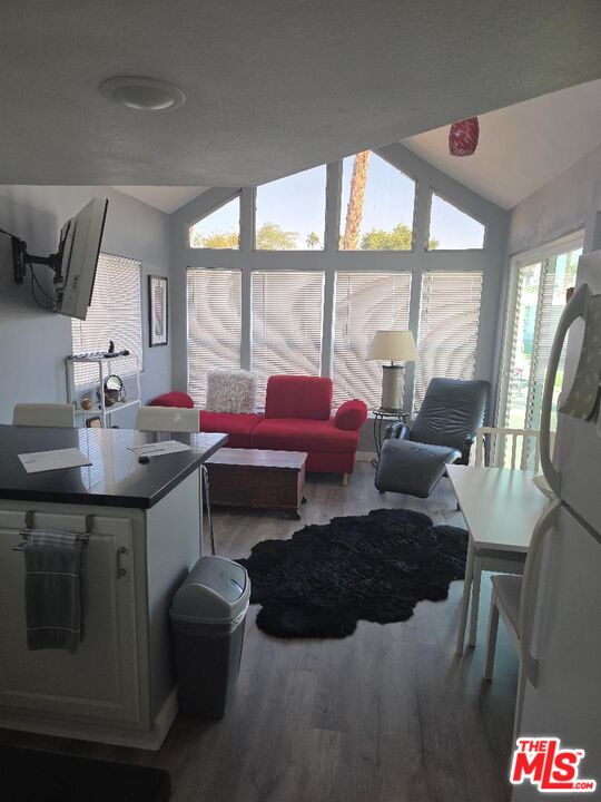 84136 Ave 44, Unit 372 Indio, CA 92203 - Photo 2 of 16 a living room with furniture and a floor to ceiling window