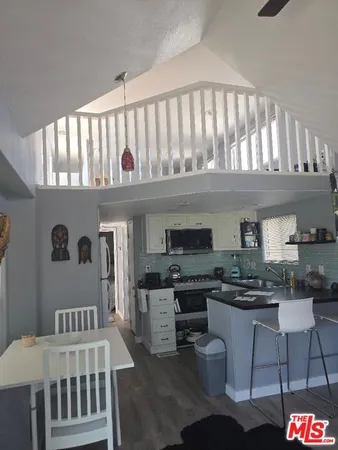 a kitchen with stainless steel appliances granite countertop a stove and cabinets