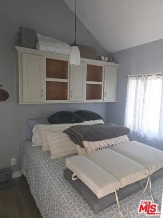 a bedroom with a bed and window