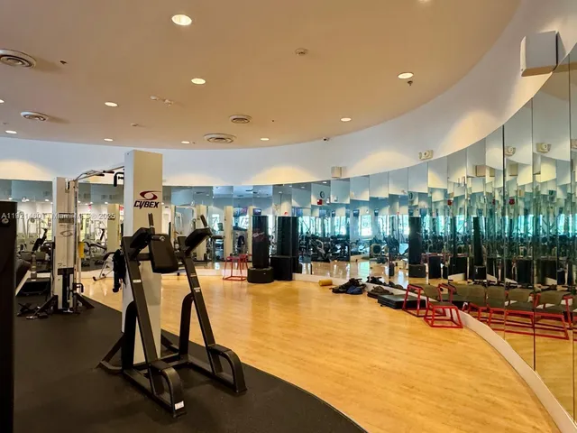 a view of swimming pool with table and chairs under an umbrella