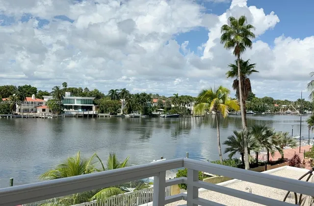 a view of a lake with houses in the background