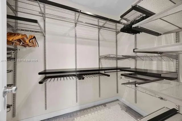 a group of white couches chairs and a chandelier