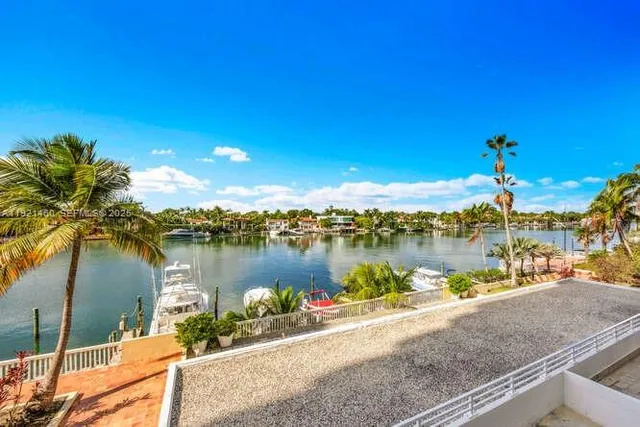 a view of swimming pool with a table under an umbrella