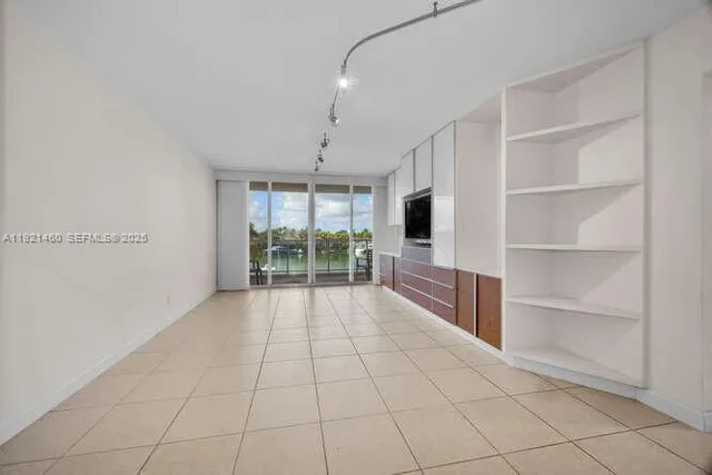 a view of an empty room and a window