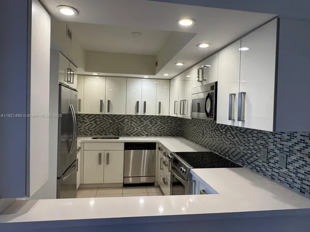 a kitchen with a sink and a refrigerator
