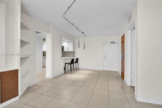 a view of a livingroom with furniture and a flat screen tv
