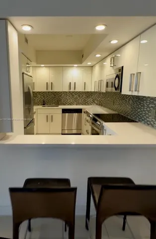 a kitchen with a table chairs stove and cabinets