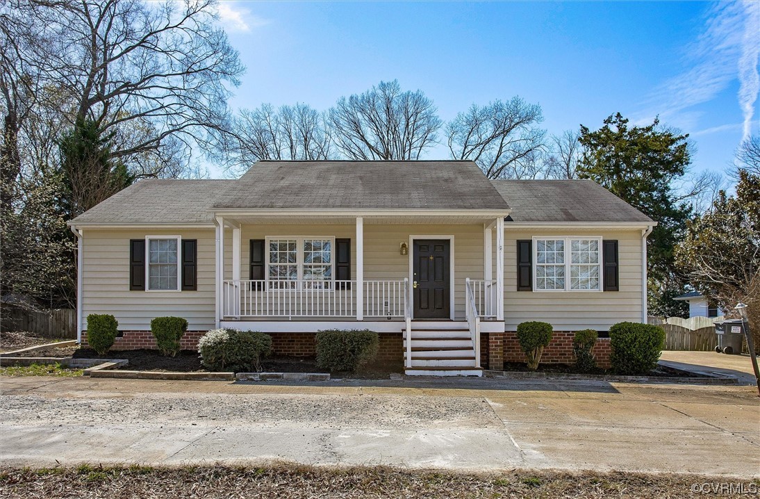a view of a house with a yard and large tree