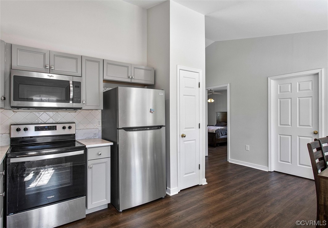 8911 Midway Road Henrico, VA 23229 - Photo 12 of 30 a kitchen with a refrigerator stove and wooden floor
