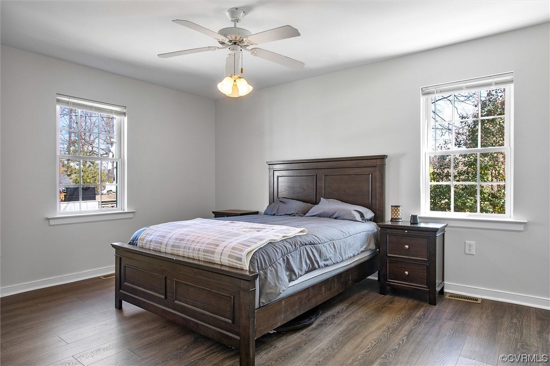8911 Midway Road Henrico, VA 23229 - Photo 15 of 30 a bedroom with a bed and wooden floor