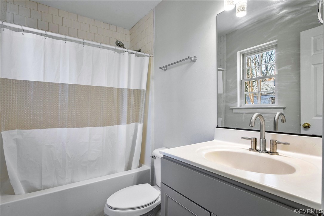 8911 Midway Road Henrico, VA 23229 - Photo 17 of 30 a bathroom with a sink toilet and shower