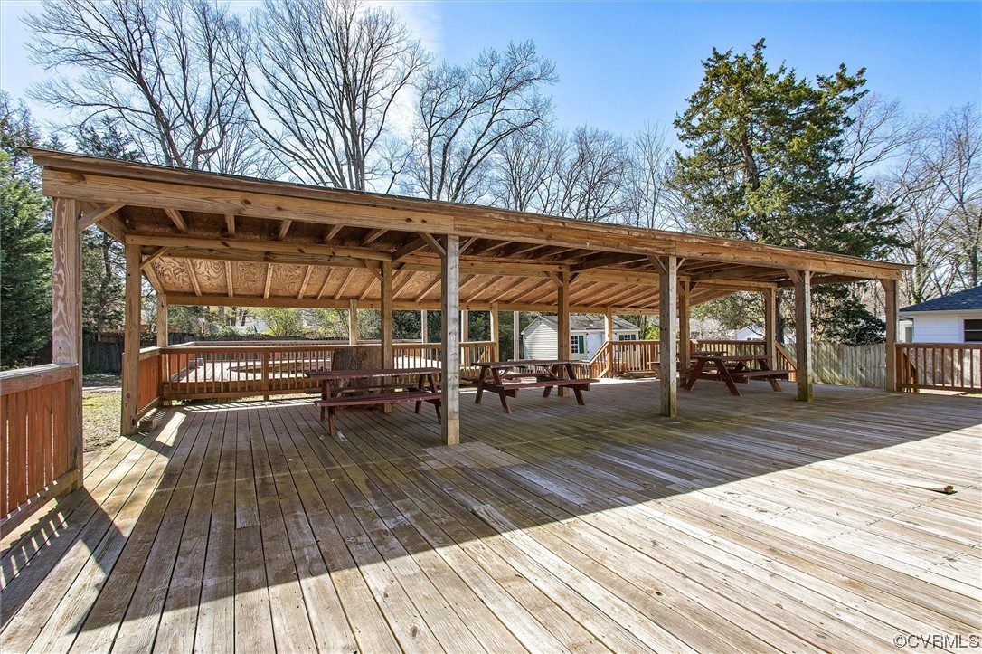 8911 Midway Road Henrico, VA 23229 - Photo 22 of 30 a view of a roof deck with table and chairs a barbeque with wooden floor and fence